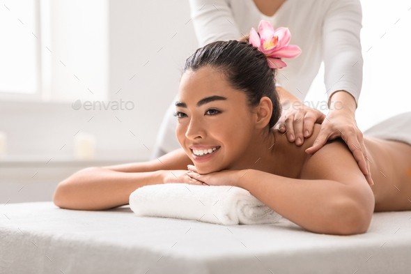 Woman getting classical back and neck massage Stock Photo by Prostock-studio