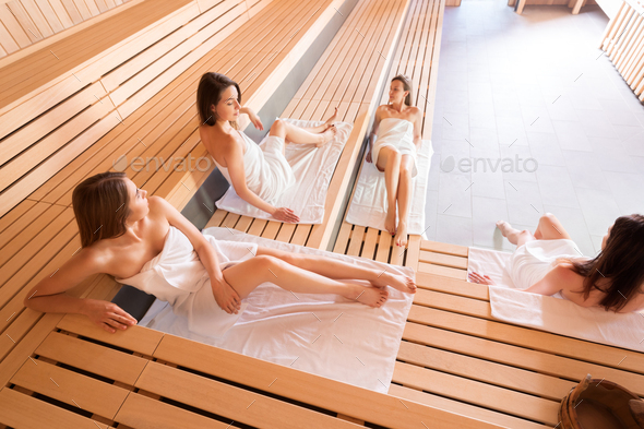 Group of women relaxing in the sauna uses spa treatment Stock Photo by  leszekglasner