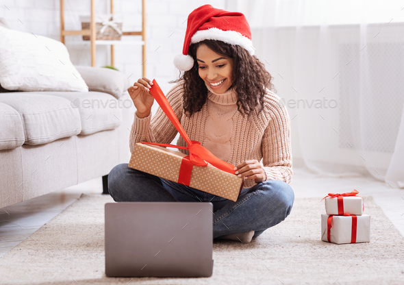 Black Woman Opening Present Box And Using Laptop Computer