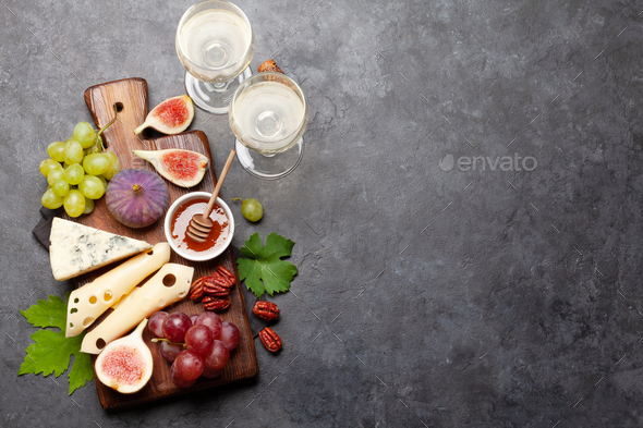 Antipasto plate with cheese, figs and grapes. Appetizer board. Top view flat lay with copy space