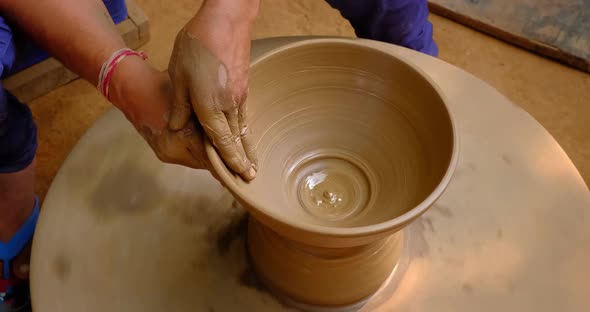 Pottery - Skilled Wet Hands of Potter Shaping the Clay on Potter Wheel. Pot, Vase Throwing alt
