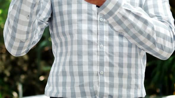 Smiling man examining a wine bottle alt