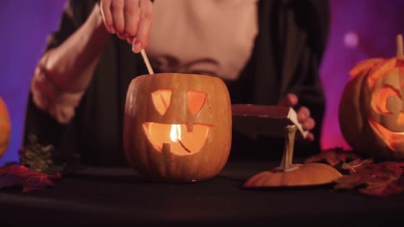 Beautiful witch lights pumpkin for halloween. Halloween!  4K. Stock video. Close up.