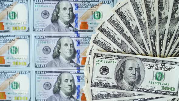 Some dollars are rotating. Background of money. American cash turning round on one hundred dollars alt