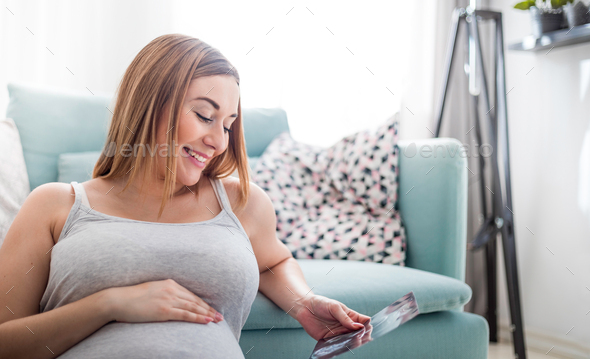 Pregnant woman looking her baby on ultrasound image, usg photo - Stock Photo - Images