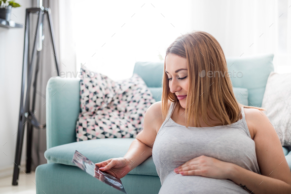 Pregnant woman looking her baby on ultrasound image, usg photo - Stock Photo - Images