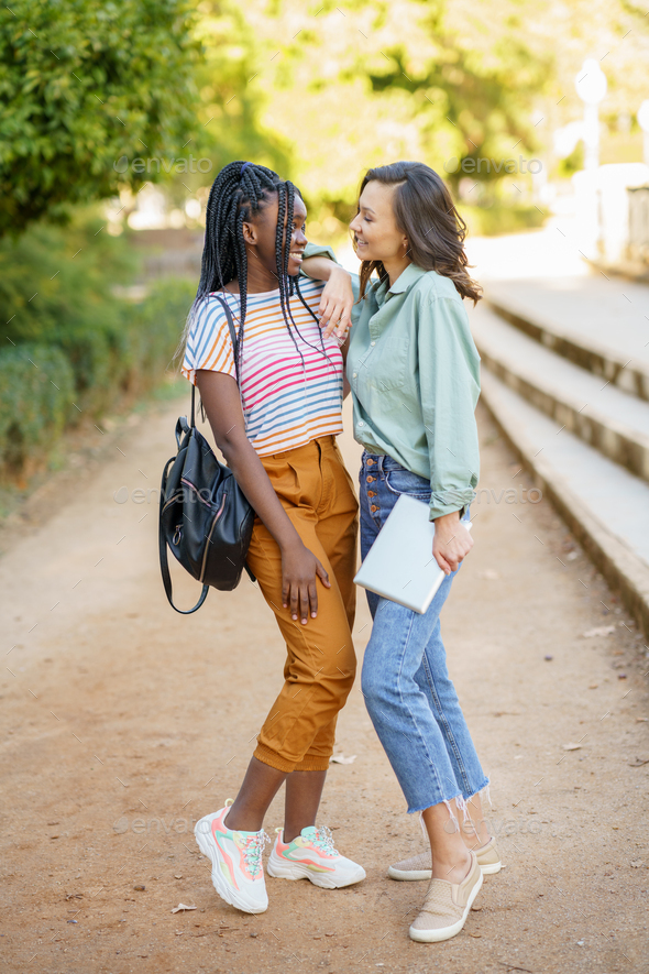 Two beautiful girls in casual clothes posing outdoor Stock Photo