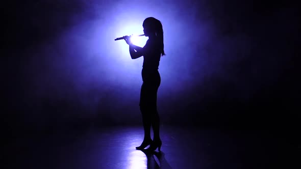 Melody Performed Girl Playing on Flute in Slow Motion. Smoky alt