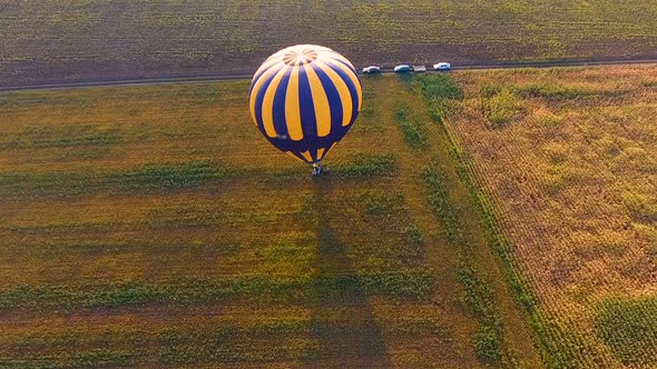 Basket of Hot Air Balloon Standing on Field, People Jumping from Gondola, Finish alt