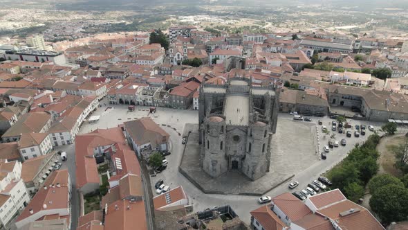 A huge gothic cathedral rises above the roofs of regular homes in Guarda, Portugal.