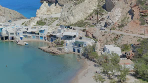 Aerial Pan of a Fishing Village on the Blue Aegean Sea in Cyclades Milos Greece alt