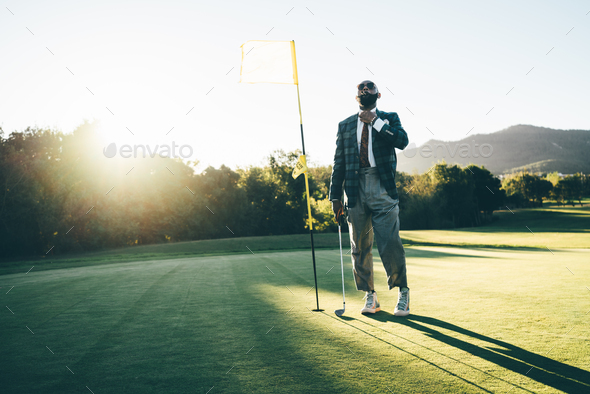 Black man in suit on a golf field