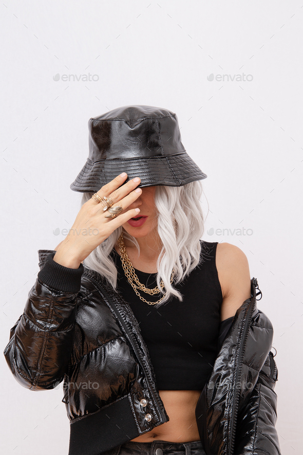 Sexy blonde model in fashion urban street outfit. Trendy black bucket hat and bomber.