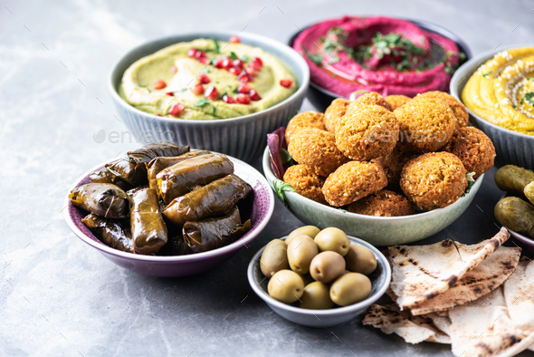 Traditional Middle Eastern assorted meze: hummus, pita, olives, pistachios, dolma, falafel balls
