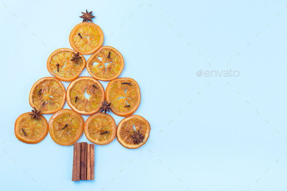 Christmas tree from orange candied slices, cinnamon sticks, anise - Stock Photo - Images