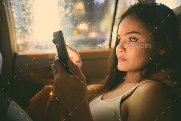 Young beautiful Asian tourist woman exploring Ho Chi Minh city in Vietnam - Stock Photo - Images