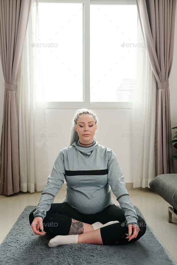Pregnant woman meditating Stock Photo by DragonImages | PhotoDune