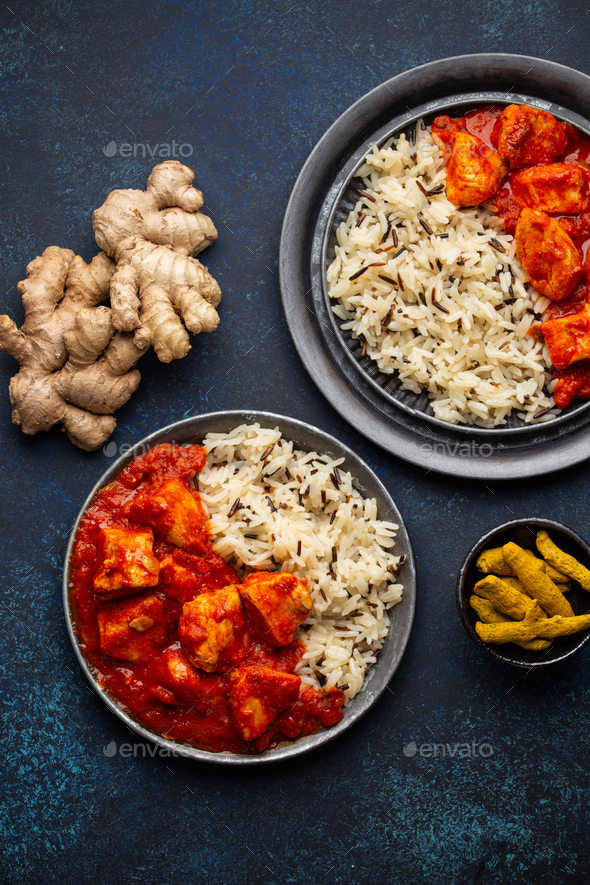 Chicken tikka masala dish with rice, flat Indian bread and spices - Stock Photo - Images