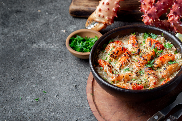 Baked crabmeat crab meat with cheese, cream and bread. Pastel o chupe de sentolla or king crab - Stock Photo - Images