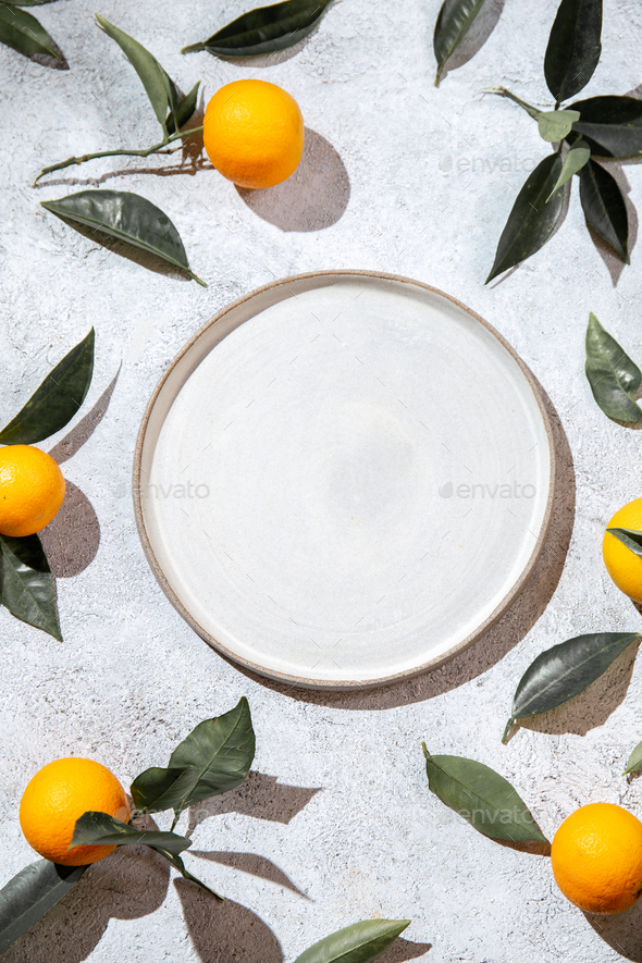 Whole oranges witl orange tree leaves on white background - Stock Photo - Images