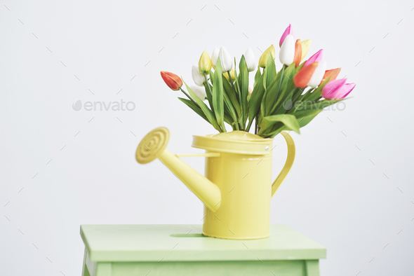 yellow funnel with small colored flowers tulps. Beutiful spring flowers