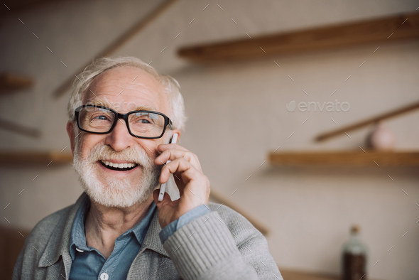 happy bearded senior man talking by phone - Stock Photo - Images