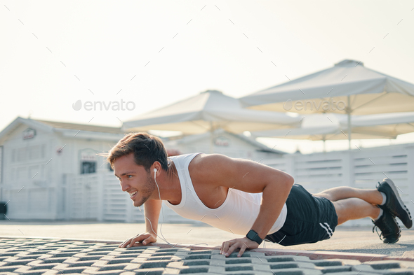 Picture of a young athletic man doing push ups, leg over leg lis