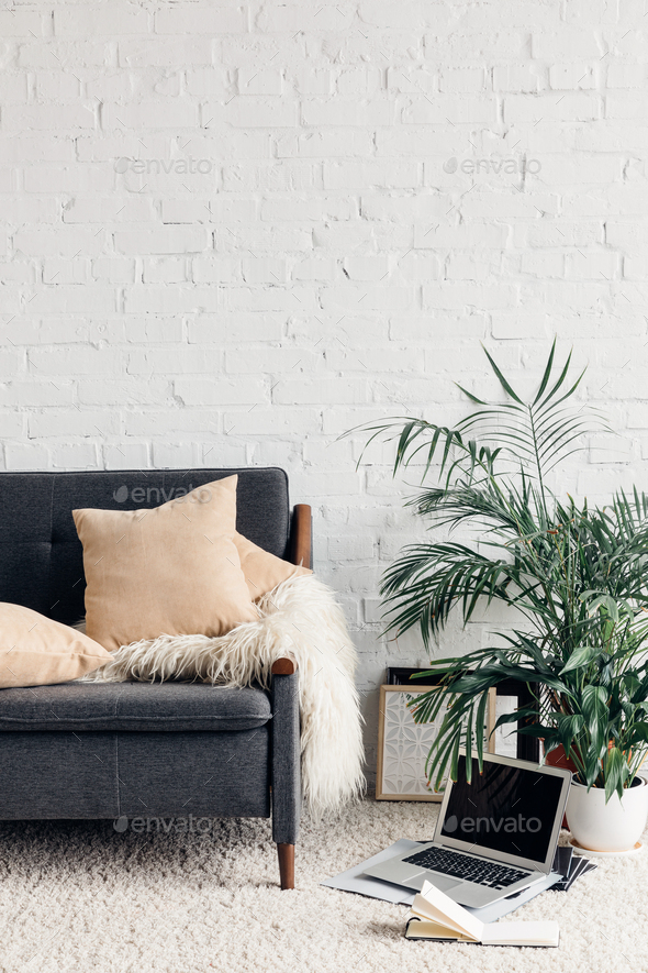 comfy couch in white living room interior with brick wall, mockup concept