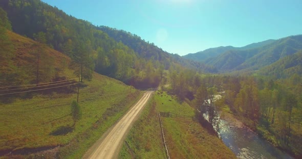 Low Altitude Flight Over Fresh Fast Mountain River with Rocks at Sunny Summer Morning. alt