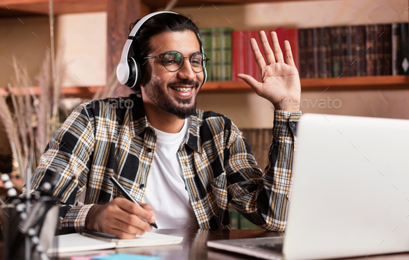 Arab Student Guy At Laptop Waving Hello Learning At Home