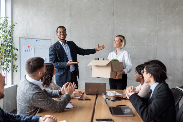 Businessman Introducing New Team Member During Corporate Meeting In Office