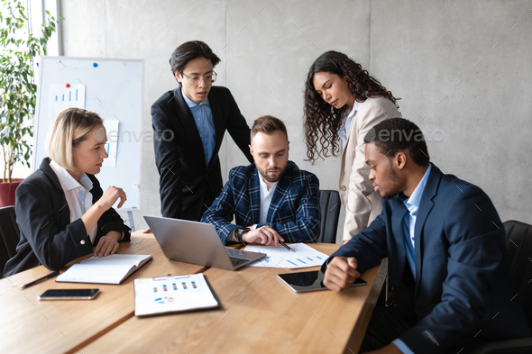 Serious Diverse Business Team Working At Laptop In Office Stock Photo by  Prostock-studio