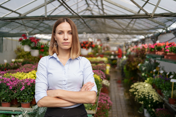 Woman entrepreneur portrait posing in her greenhouse