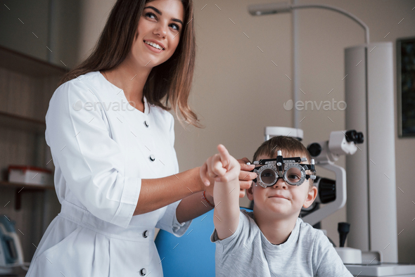 Child sitting in the doctor's cabinet and have tested his visual acuity