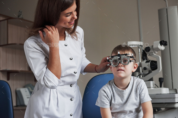 Reading the letters. Child sitting in the doctor's cabinet and have tested his visual acuity