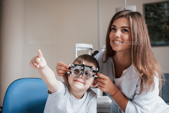 Child sitting in the doctor's cabinet and have tested his visual acuity