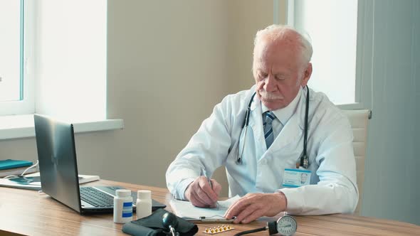 Doctor filling up medical documents