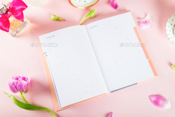 Open Notebook for writing Dreams and Ideas with flowers nearby