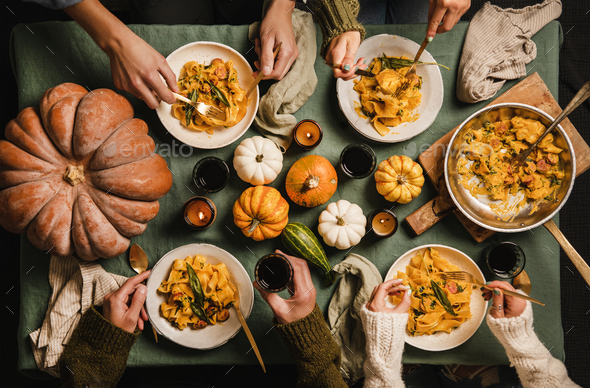 People eating squash pasta with sausage on Thanksgiving day