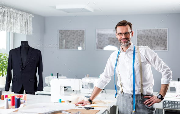 Professional dressmaker woman sews clothes on sewing machine at fashion  design workshop Stock Photo by leszekglasner