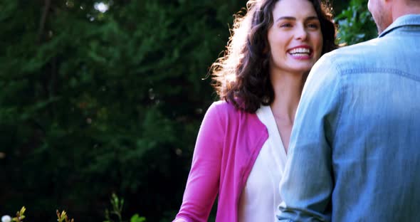 Romantic couple embracing each other in garden alt