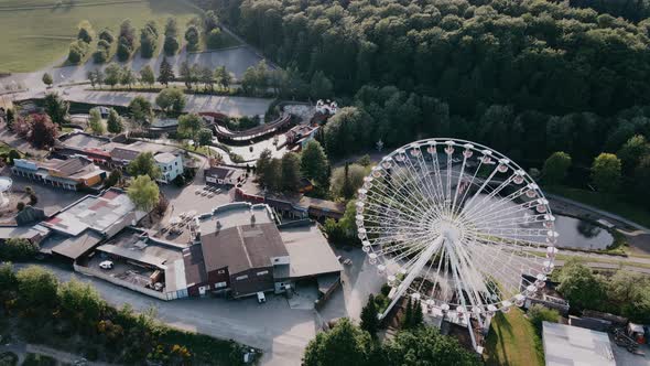 Drone View of Resort with Ferris Wheel in the Hills in Sunny Weather