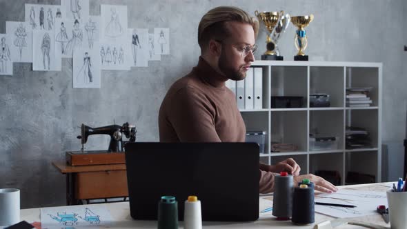 Workplace of young and talented fashion designer. alt