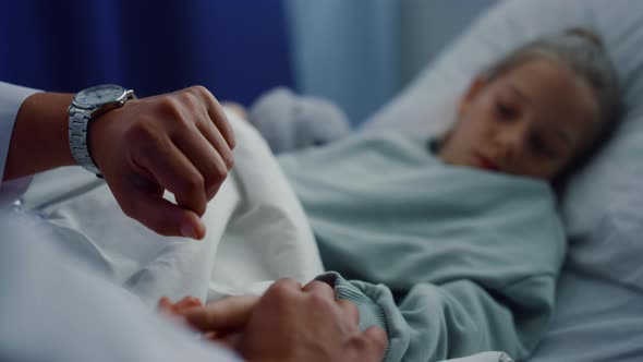 Doctor Hands Checking Pulse Manually Closeup alt