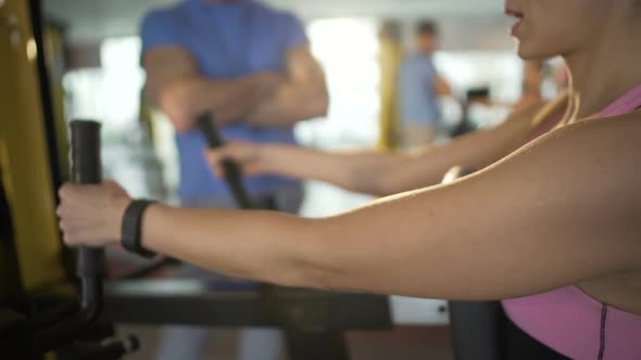 Personal Trainer Giving Advice to Woman During Workout in Gym, Healthy Lifestyle alt