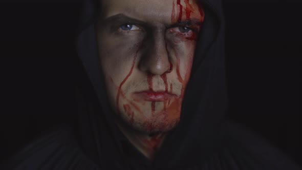 Man Executioner Halloween Makeup and Costume. Guy with Blood on His Face alt