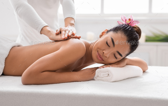 Woman getting classical back and neck massage Stock Photo by Prostock-studio