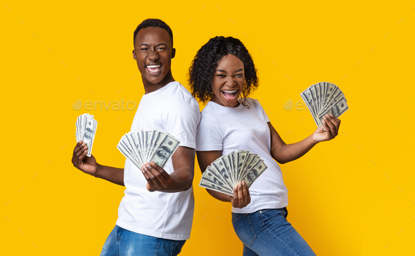 Emotional black couple dancing with bunch of money banknotes Stock ...