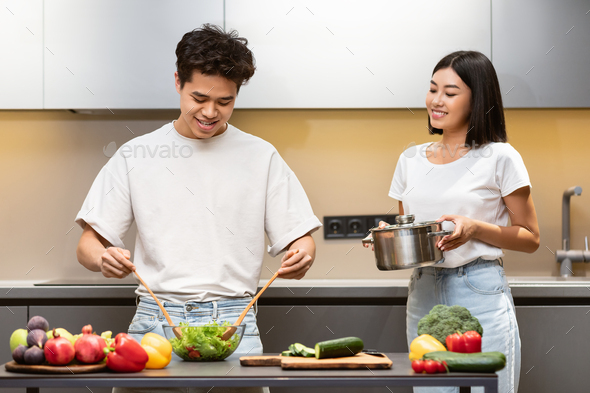 Asian family is cooking in the kitchen together