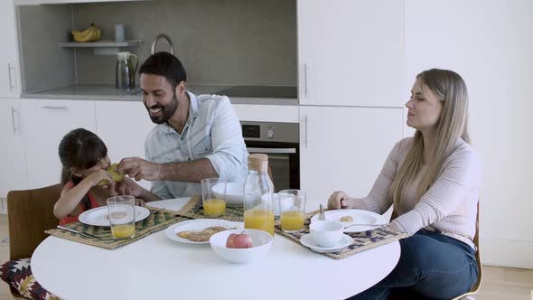 Parents Couple and Little Girl Having Breakfast Together alt